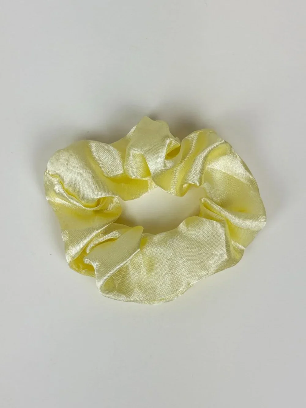 Pale yellow satin scrunchie. New without tags. Never used. Unbranded
